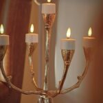 Een goudkleurige kandelaar met vijf LED waxinelichtjes 3D (175 uur brandtijd, oplaadbaar) creëert een warme, elegante sfeer binnenshuis; inclusief afstandsbediening, timer en wordt geleverd in een set van 12.