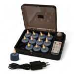 Een zwarte oplaadbox met 12 blauwe oplaadbare waxinelichtjes (Stone Bleu No.86, brandtijd tot 400 uur), een afstandsbediening, één theelichtje buiten de koffer, plus een zwarte voedingsadapter en kabel aan de voorkant.